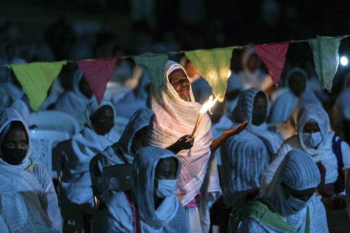 Ethiopian Orthodox Christians light candles and pray for peace (AP Photo/Mulugeta Ayene)