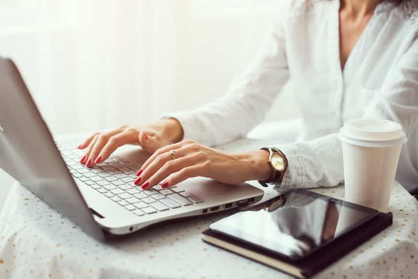 Woman typing on laptop email